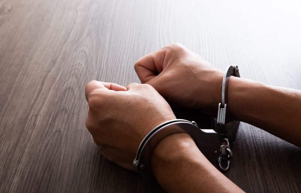 What to expect upon arrest 8 Criminal hands locked in handcuffs.